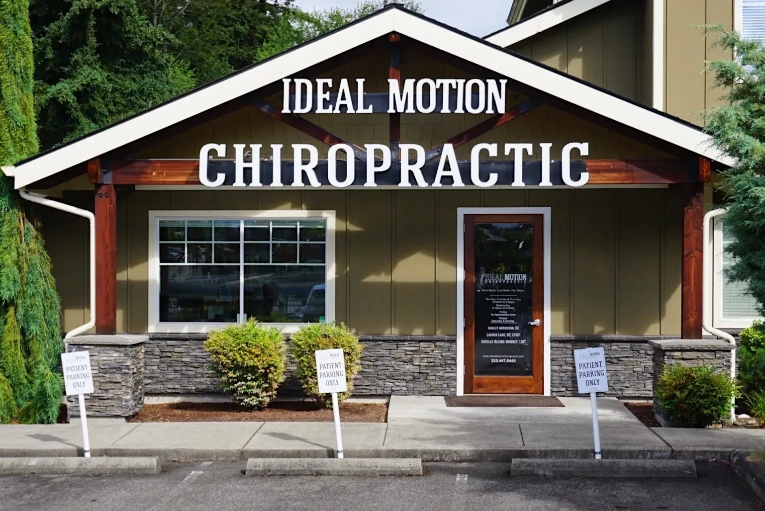 A chiropractic office with signs on the front of it.