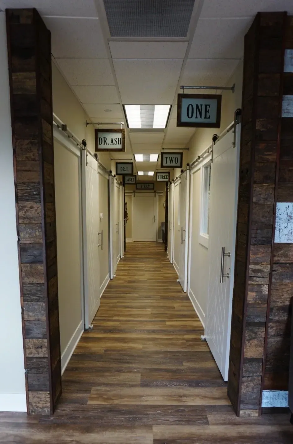 A hallway with two doors and one door open.