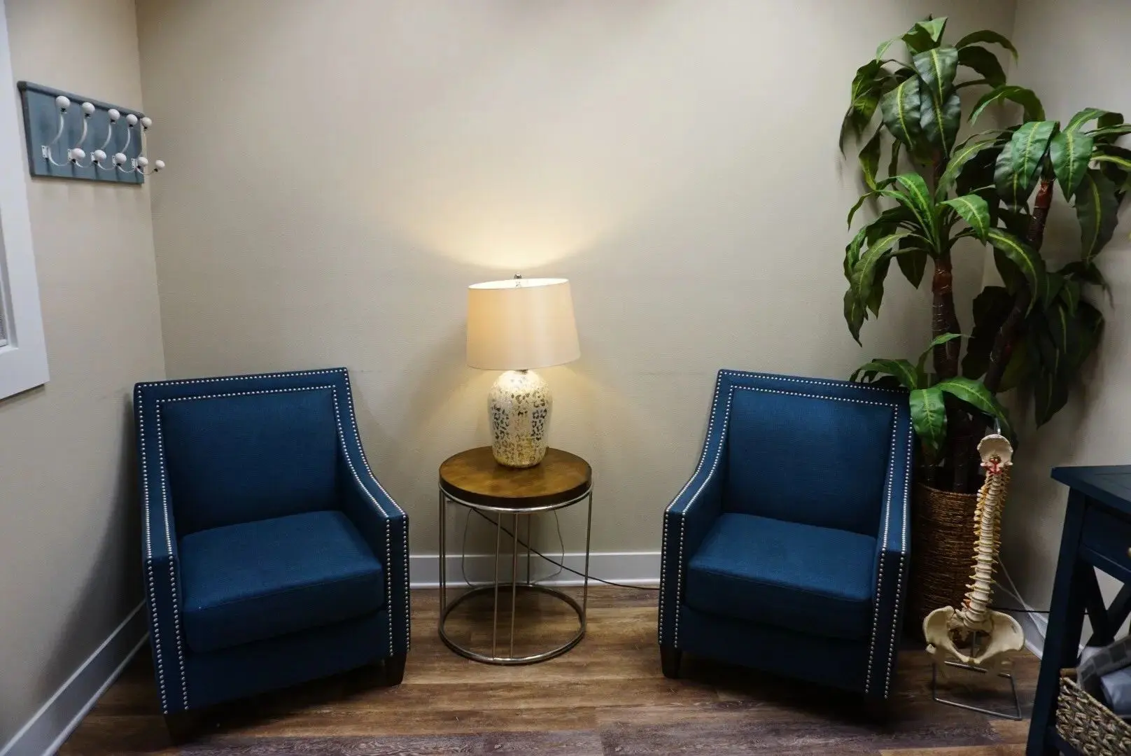 Two blue chairs and a table with a lamp